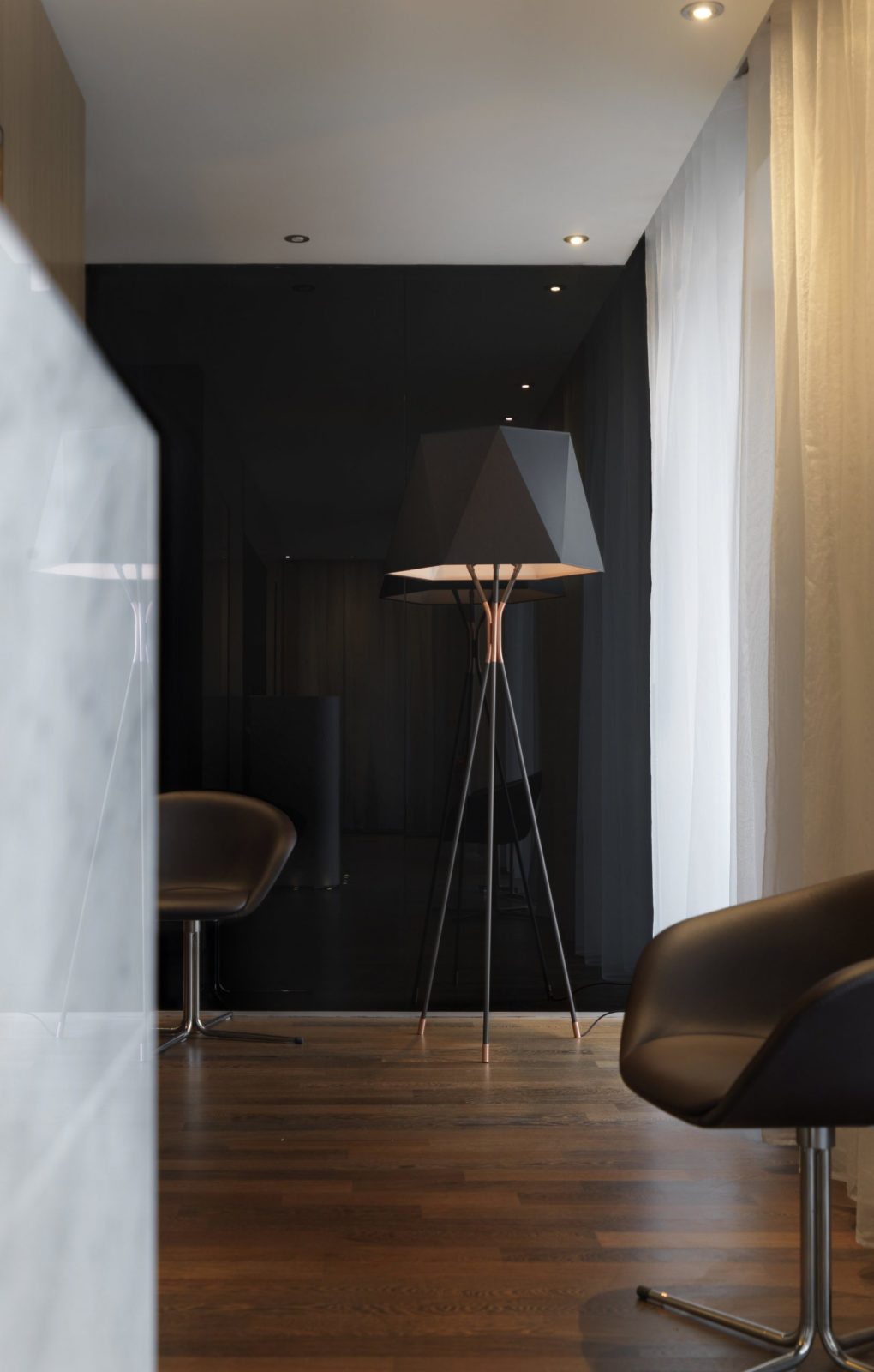 modern-solitaire-tripod-floor-lamp-with-black-polygonal-cloth-shade-and-brass-accents