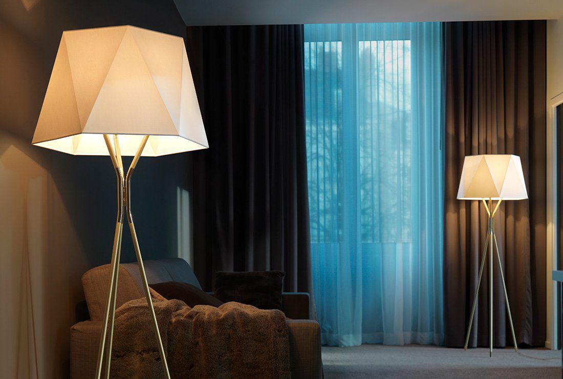 modern-solitaire-tripod-floor-lamp-with-black-polygonal-cloth-shade-and-brass-accents