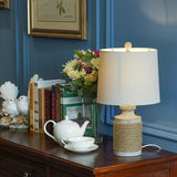 Vintage Coastal Style Stone Table Lamp with Rope Accents and Tapered Oatmeal Fabric Drum Shade